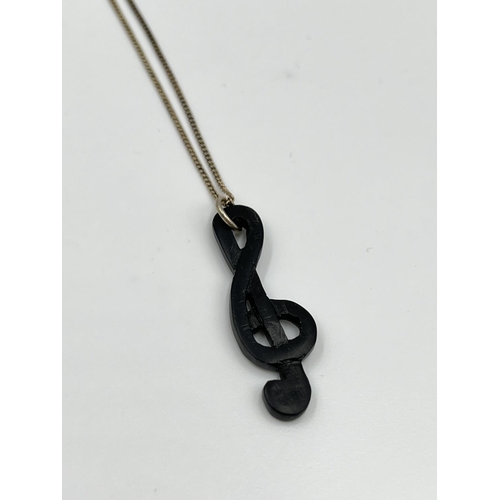 2327 - A .925 sterling silver necklace with black treble clef pendant - approx. gross weight 2.65 grams