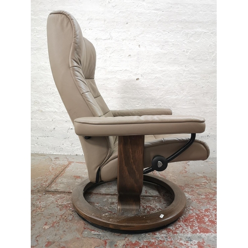 1072B - An Ekornes Stressless light brown leather armchair with stool - approx. 98cm high x 75cm wide x 62cm... 