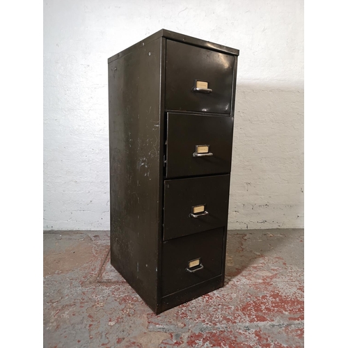 1073D - A mid 20th century military green metal four drawer office filing cabinet - approx. 132cm high x 47c... 