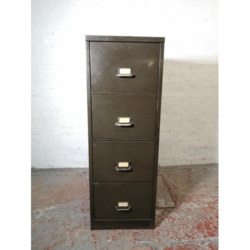 1073D - A mid 20th century military green metal four drawer office filing cabinet - approx. 132cm high x 47c... 