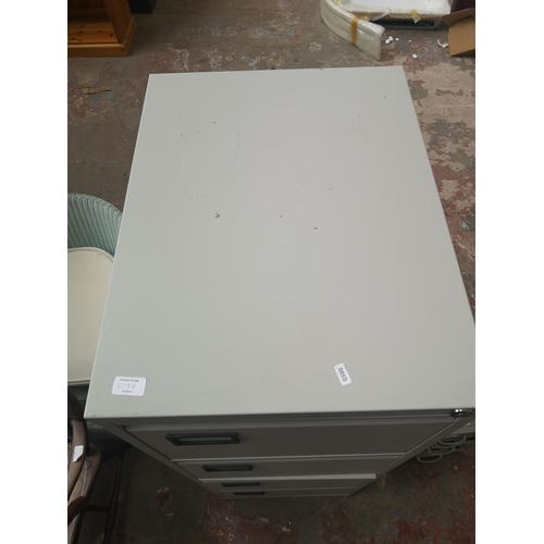 1117F - A grey metal four drawer office filing cabinet - approx. 132cm high x 47cm wide x 62cm deep