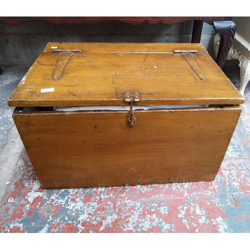 1147A - An early 20th century stained pine travel trunk with contents - approx. 42cm high x 72cm wide x 51cm... 