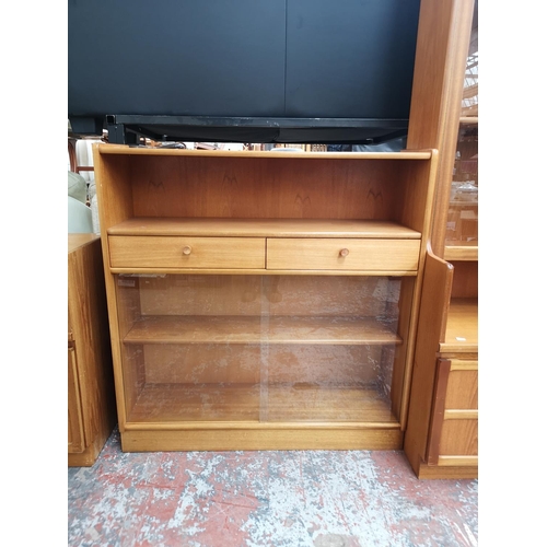 1159 - A Nathan teak bookcase with two drawers, two sliding glass doors and two internal shelves - approx. ... 