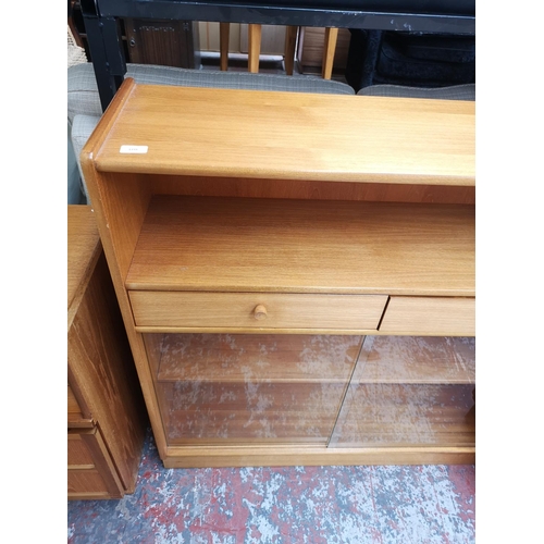 1159 - A Nathan teak bookcase with two drawers, two sliding glass doors and two internal shelves - approx. ... 