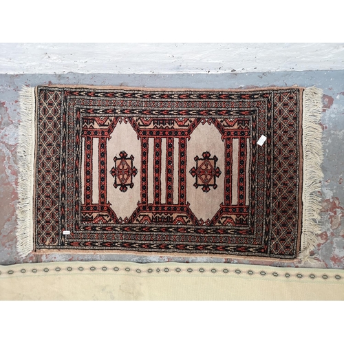 1159A - Two vintage rugs, one 1950s Turkish with red, black and beige motifs - approx. 115cm x 65cm and one ... 