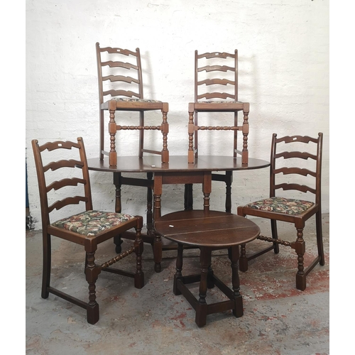 1165 - A Jaycee oak drop leaf gate leg dining table with four matching chairs and one smaller matching drop... 