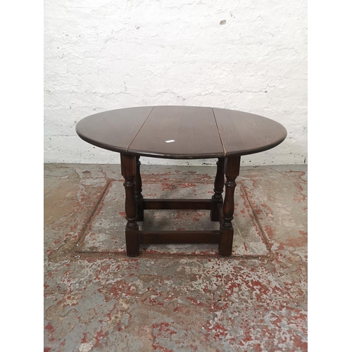 1165 - A Jaycee oak drop leaf gate leg dining table with four matching chairs and one smaller matching drop... 