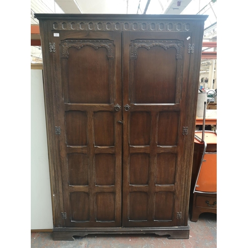 1167 - A mid 20th century oak double wardrobe - approx. 187cm high x 123cm wide x 55.5cm deep