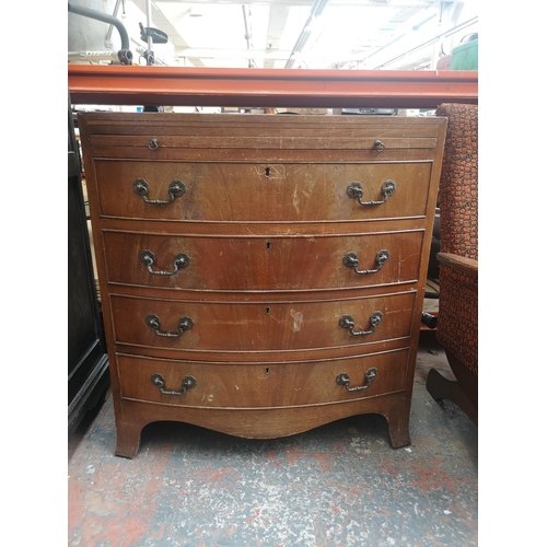 1168 - A Harvey Nichols & Co. Ltd. mahogany bow fronted chest of four drawers with brushing slide - approx.... 