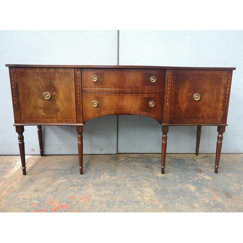 1173 - A Regency style mahogany bow fronted sideboard with two central drawers, two outer cupboard doors an... 