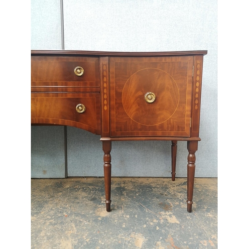 1173 - A Regency style mahogany bow fronted sideboard with two central drawers, two outer cupboard doors an... 