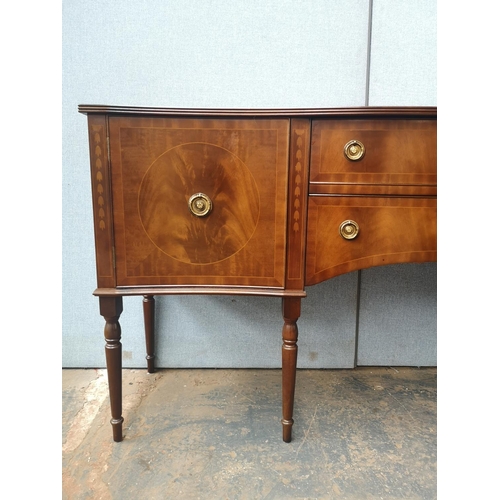 1173 - A Regency style mahogany bow fronted sideboard with two central drawers, two outer cupboard doors an... 