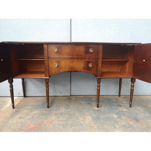 1173 - A Regency style mahogany bow fronted sideboard with two central drawers, two outer cupboard doors an... 