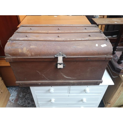 1119A - An early 20th century brown metal travel trunk with contents - approx. 48cm high x 78cm wide x 54cm ... 