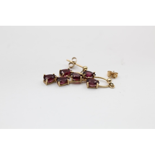 2165 - A pair of 9ct gold garnet drop earrings - approx. gross weight 2.1 grams