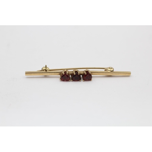 2168 - Two 9ct gold heart gemstone bar brooches, one garnet and one sapphire - approx. gross weight 4 grams