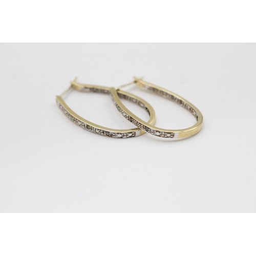 2177 - A pair of 9ct gold diamond framed hoop earrings - approx. gross weight 3.2 grams