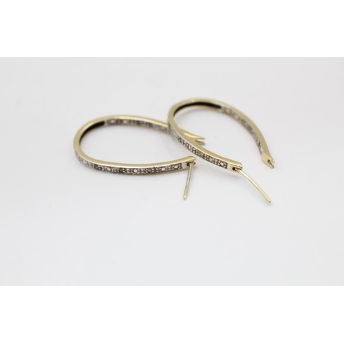 2177 - A pair of 9ct gold diamond framed hoop earrings - approx. gross weight 3.2 grams