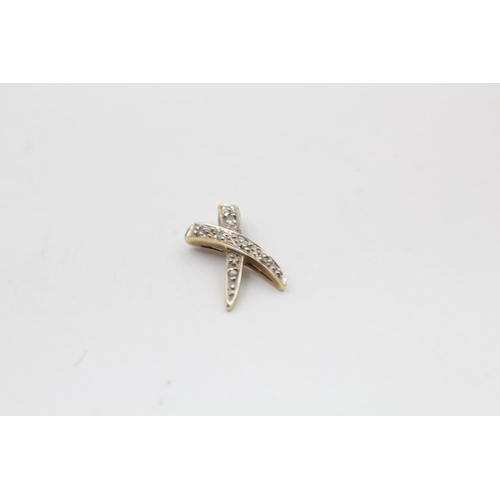 2185 - A 9ct gold diamond cross motif pendant and stud earrings - approx. gross weight 1.8 grams