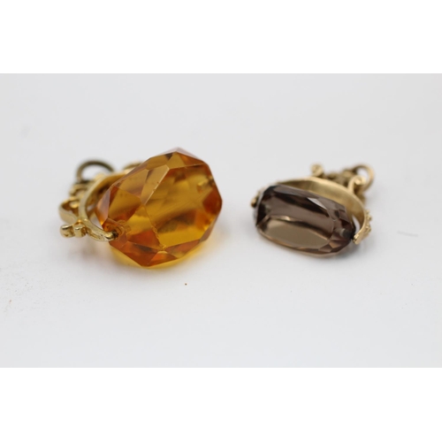 2223 - Two 9ct gold gemstone spinner fob pendants, one citrine and one smoky quartz  -approx. gross weight ... 