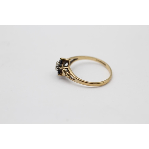 2244 - A 9ct gold sapphire framed diamond floral set ring, size L½ - approx. gross weight 1.3 grams