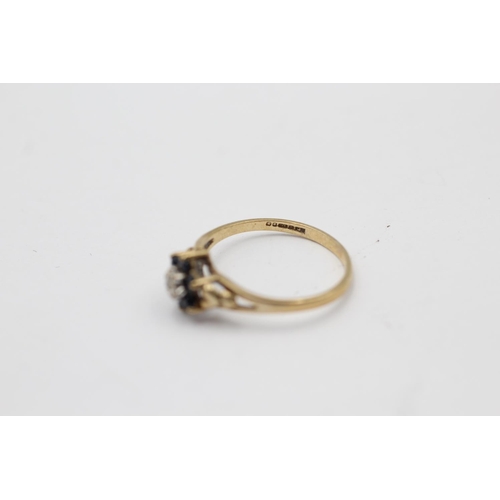 2244 - A 9ct gold sapphire framed diamond floral set ring, size L½ - approx. gross weight 1.3 grams