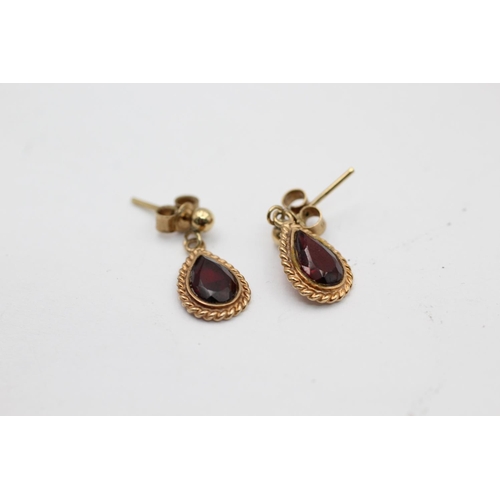 2254 - Two pairs of 9ct gold garnet drop earrings - approx. gross weight 3.1 grams