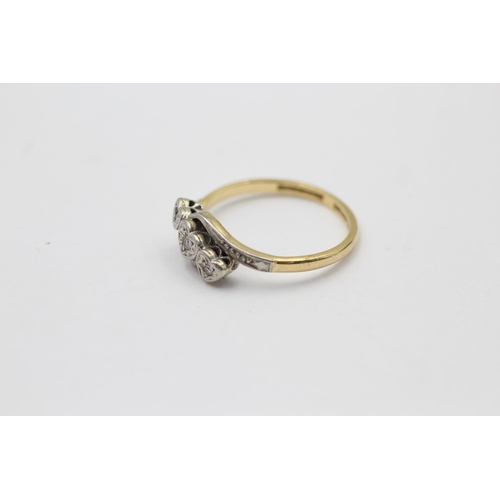 2261 - An 18ct gold and platinum diamond trio bypass band ring, size O - approx. gross weight 2.7 grams