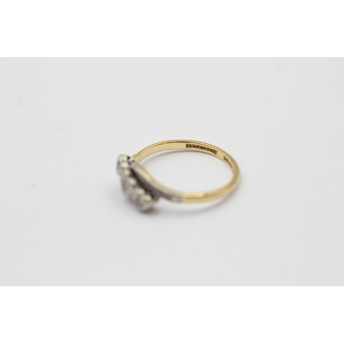 2261 - An 18ct gold and platinum diamond trio bypass band ring, size O - approx. gross weight 2.7 grams