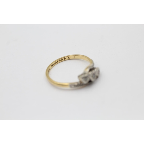 2261 - An 18ct gold and platinum diamond trio bypass band ring, size O - approx. gross weight 2.7 grams