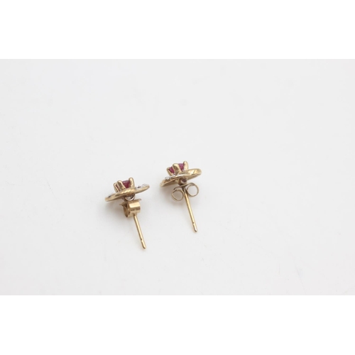 2266 - A pair of 9ct gold ruby and diamond swirl stud earrings - approx. gross weight 1.2 grams