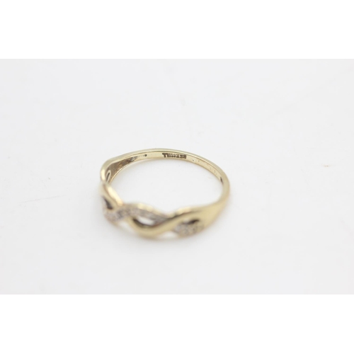 2279 - A 9ct gold diamond set infinity wave design ring, size K - approx. gross weight 1.1 grams