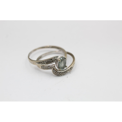 2281 - A 9ct white gold topaz and diamond twist setting stacking rings set, size M - approx. gross weight 1... 