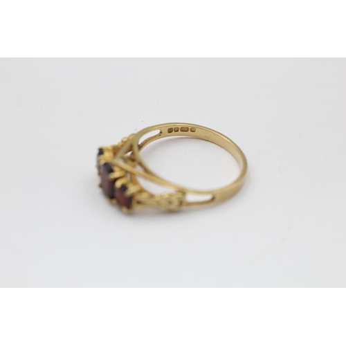 2290 - A hallmarked London 9ct gold three stone garnet ring, size Q½ - approx. gross weight 2.8 grams