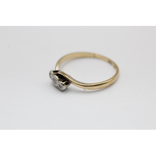 2295 - A 9ct gold and platinum diamond bypass band ring, size P½ - approx. gross weight 1.5 grams