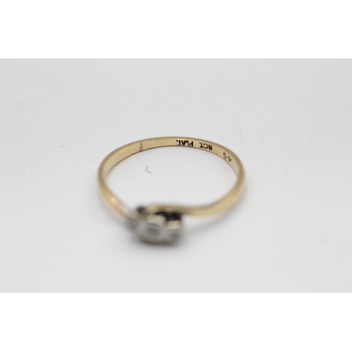 2295 - A 9ct gold and platinum diamond bypass band ring, size P½ - approx. gross weight 1.5 grams