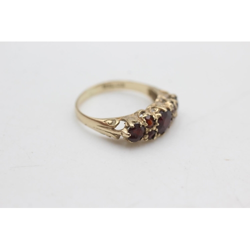 2296 - A 9ct gold garnet gypsy set ring, size N - approx. gross weight 2.1 grams