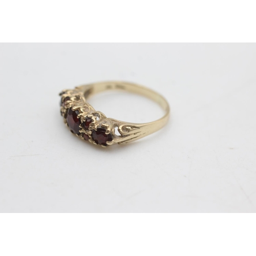 2296 - A 9ct gold garnet gypsy set ring, size N - approx. gross weight 2.1 grams