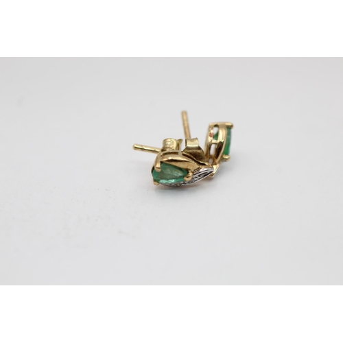 2297 - Two pairs of 9ct gold emerald and diamond stud earrings - approx. gross weight 1.5 grams