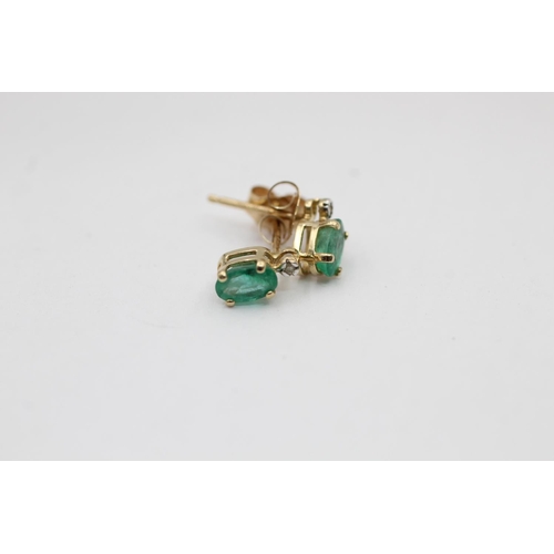 2297 - Two pairs of 9ct gold emerald and diamond stud earrings - approx. gross weight 1.5 grams