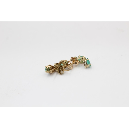 2297 - Two pairs of 9ct gold emerald and diamond stud earrings - approx. gross weight 1.5 grams