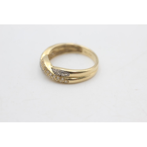 2320 - A hallmarked Sheffield 14ct gold two tone diamond twist front ring, size T - approx. gross weight 3.... 