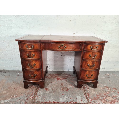 1108A - A Regency style mahogany serpentine pedestal desk with nine drawers and tan leather insert - approx.... 