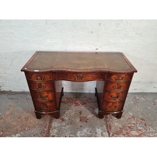 1108A - A Regency style mahogany serpentine pedestal desk with nine drawers and tan leather insert - approx.... 