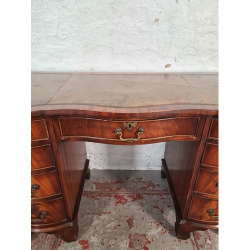 1108A - A Regency style mahogany serpentine pedestal desk with nine drawers and tan leather insert - approx.... 