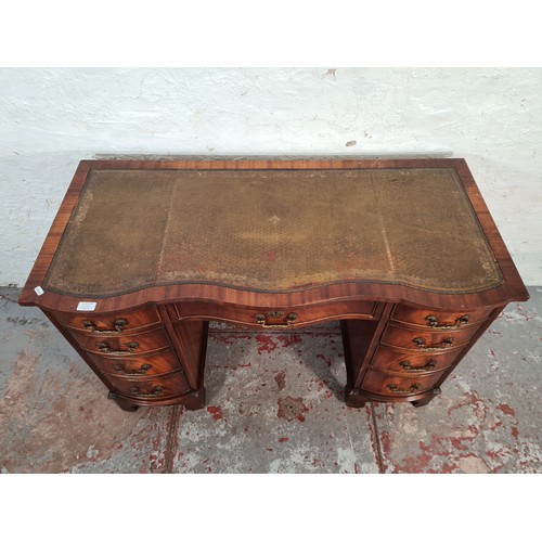 1108A - A Regency style mahogany serpentine pedestal desk with nine drawers and tan leather insert - approx.... 