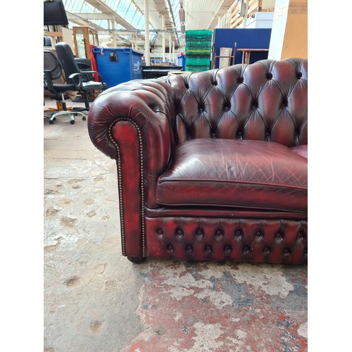 1176A - An oxblood leather chesterfield 3-seater sofa - approx. 83cm high x 238cm wide x 93cm deep