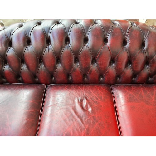 1176A - An oxblood leather chesterfield 3-seater sofa - approx. 83cm high x 238cm wide x 93cm deep