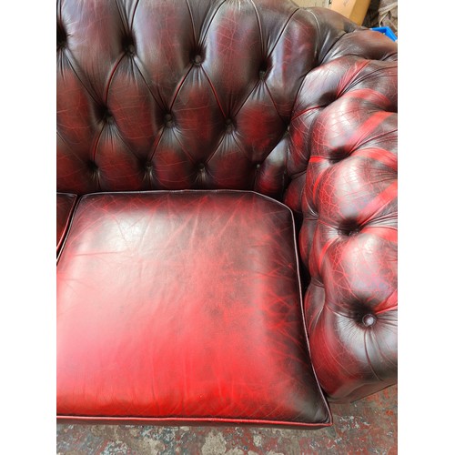 1176A - An oxblood leather chesterfield 3-seater sofa - approx. 83cm high x 238cm wide x 93cm deep