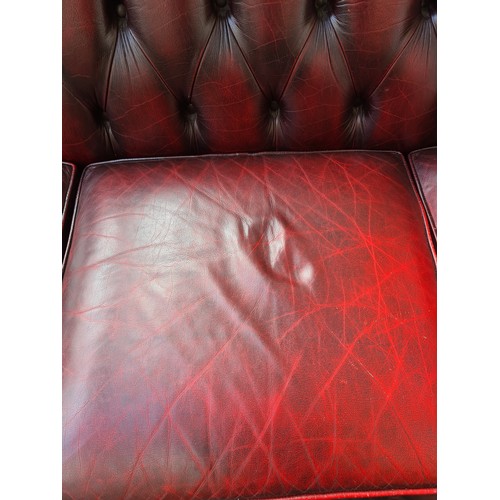 1176A - An oxblood leather chesterfield 3-seater sofa - approx. 83cm high x 238cm wide x 93cm deep